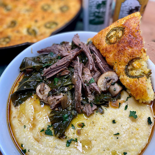 Braised Short Rib w/ Collard greens over Cheesy Grits & Jalapeno Cornbread